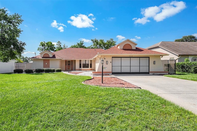 ranch-style house featuring a front lawn and a garage