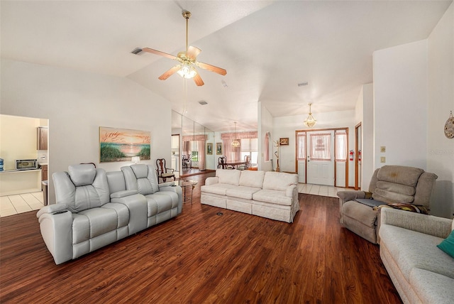 living room featuring ceiling fan, dark wood-type flooring, and lofted ceiling