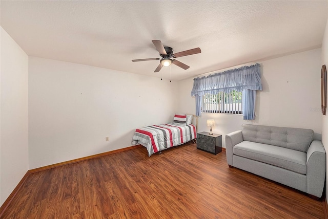 bedroom with a textured ceiling, dark hardwood / wood-style floors, and ceiling fan