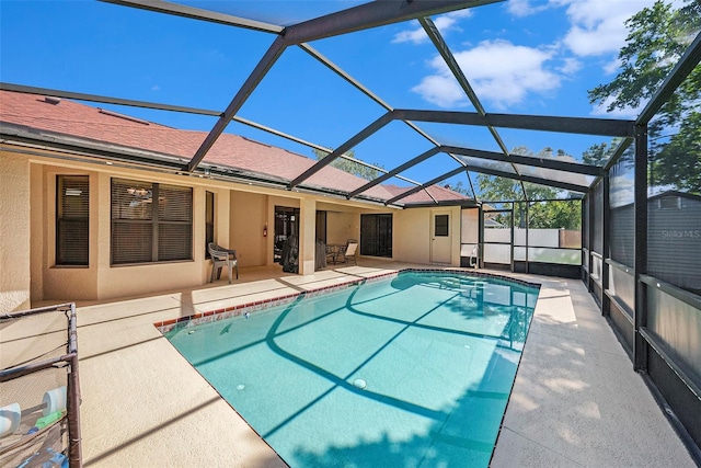 view of swimming pool featuring a lanai and a patio area