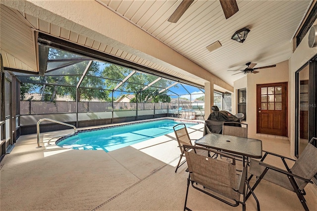 view of swimming pool with a patio, ceiling fan, and a lanai