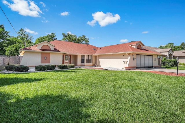 ranch-style house featuring a front yard and a garage