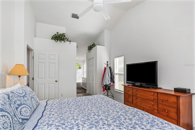 bedroom with hardwood / wood-style floors, ceiling fan, high vaulted ceiling, ensuite bathroom, and a closet