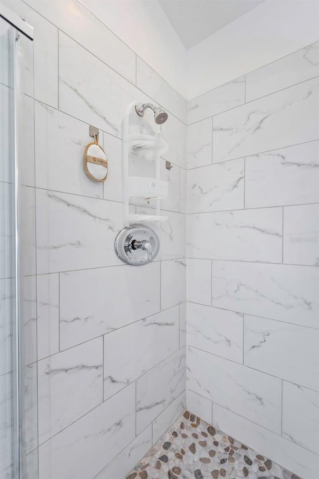 bathroom with a tile shower