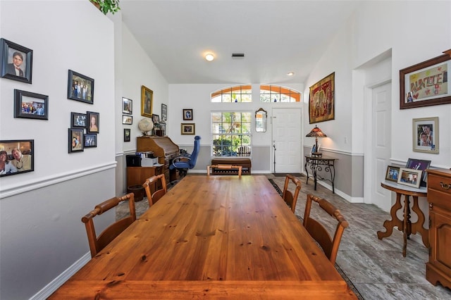 dining space featuring vaulted ceiling