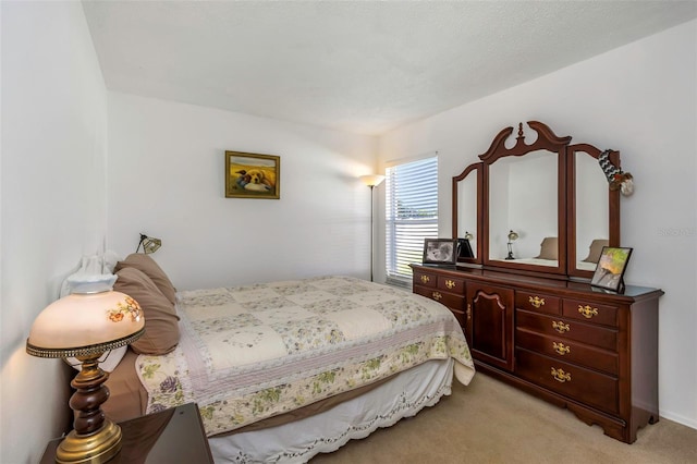 bedroom featuring light carpet