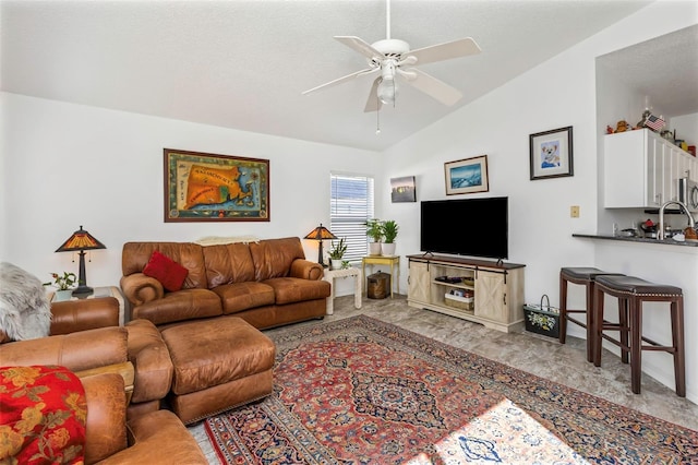 living room featuring ceiling fan and vaulted ceiling