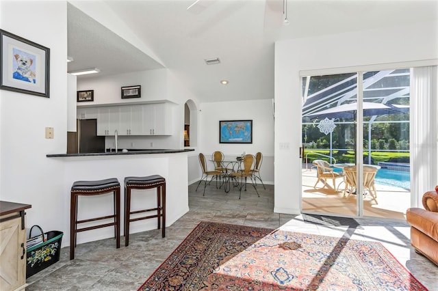 kitchen with white cabinetry, a wealth of natural light, and kitchen peninsula