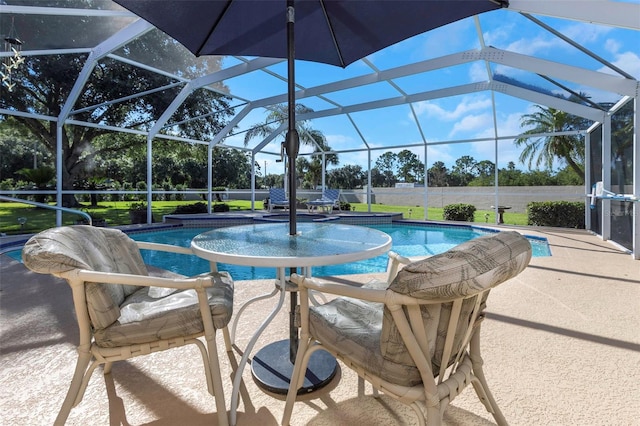 view of swimming pool featuring a patio area and glass enclosure