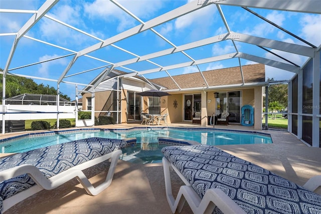 view of pool with a patio and glass enclosure