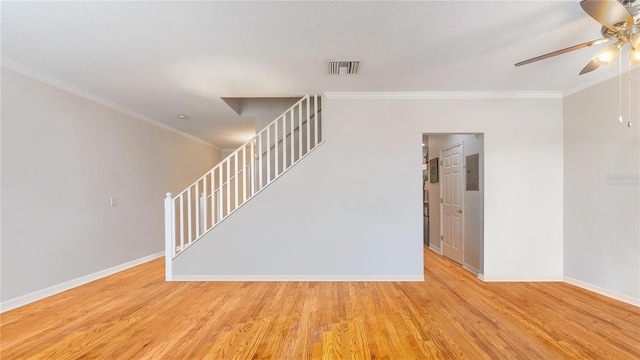 unfurnished room with ceiling fan, ornamental molding, and light hardwood / wood-style floors