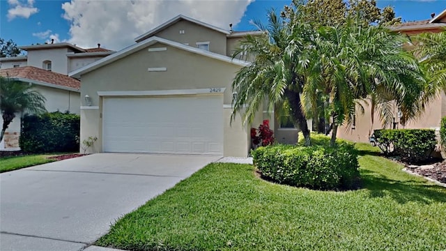 view of front of property featuring a garage and a front lawn