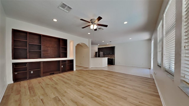 unfurnished living room featuring light hardwood / wood-style flooring and ceiling fan