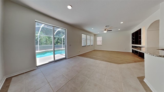 interior space with light wood-type flooring and ceiling fan