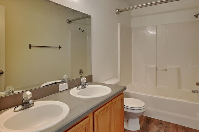 full bathroom featuring vanity, toilet, hardwood / wood-style floors, and shower / bath combination