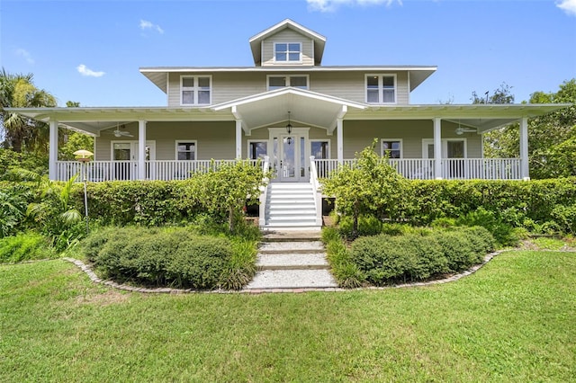 country-style home featuring ceiling fan, a porch, and a front yard