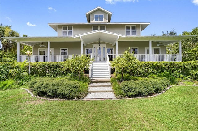 1215 Bayshore Dr, Terra Ceia, FL 34250 - farmhouse with covered porch, a front yard, and stairway