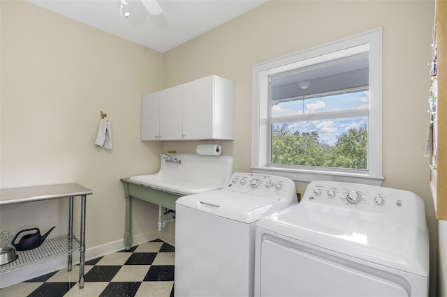 washroom featuring washer and clothes dryer, ceiling fan, and cabinets