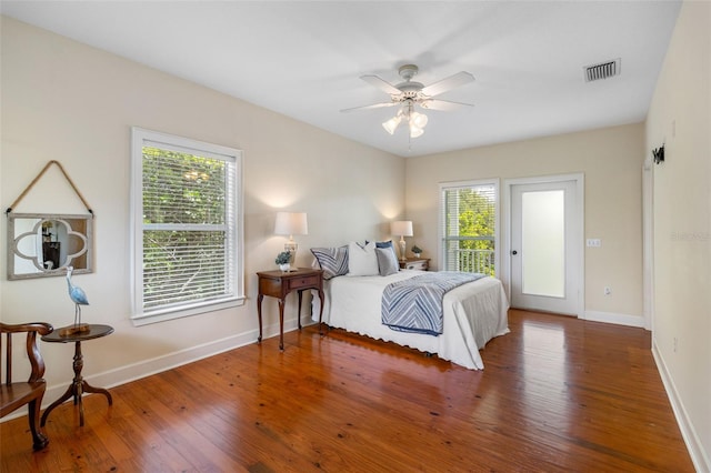 1215 Bayshore Dr, Terra Ceia, FL 34250 - bedroom with baseboards, wood finished floors, ceiling fan, and access to exterior