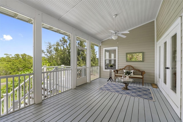 sunroom / solarium with ceiling fan and lofted ceiling