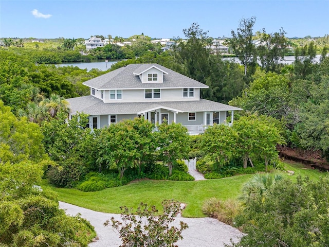 1215 Bayshore Dr, Terra Ceia, FL 34250 - view of front of home with roof with shingles, a front yard, and a water view