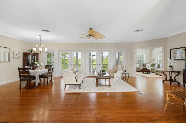 1215 Bayshore Dr, Terra Ceia, FL 34250 - living area featuring a chandelier, healthy amount of natural light, french doors, wood finished floors, and crown molding