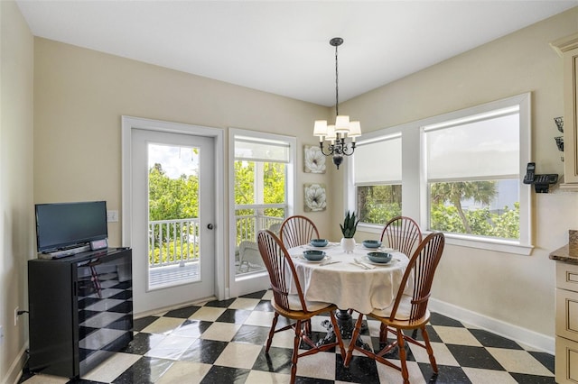 dining space with an inviting chandelier, dark floors, baseboards, and a wealth of natural light