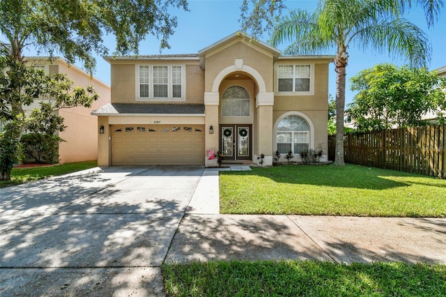 view of front of home featuring a front yard and a garage