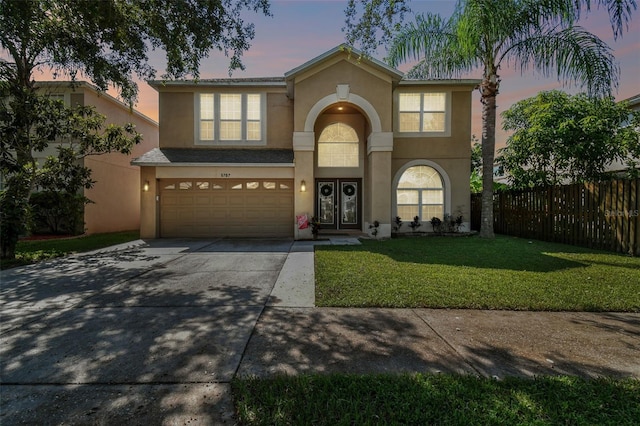 view of front of house with a yard and a garage