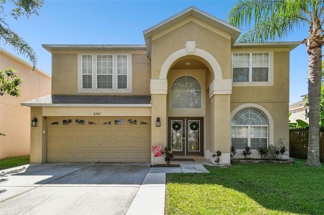 view of front of house featuring a garage and a front lawn