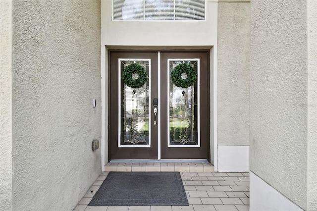 view of exterior entry featuring french doors