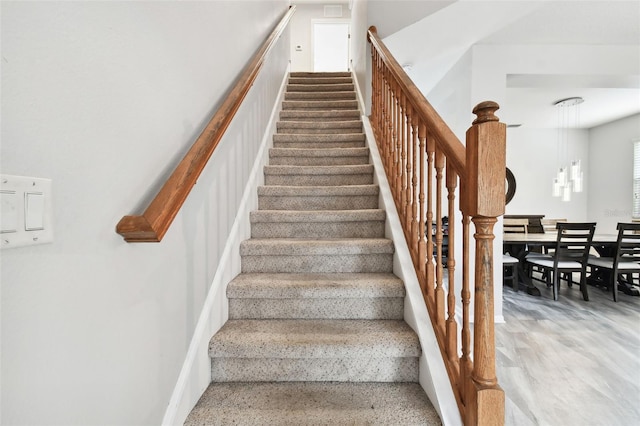 stairs with hardwood / wood-style flooring