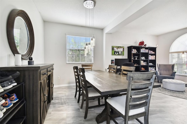 dining area featuring a textured ceiling and a notable chandelier