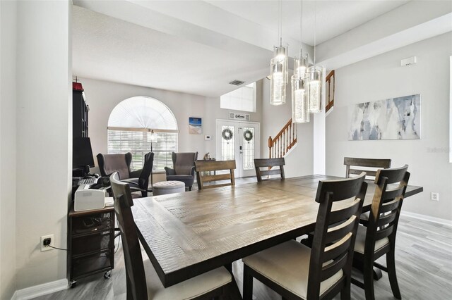 dining room featuring wood-type flooring and an inviting chandelier