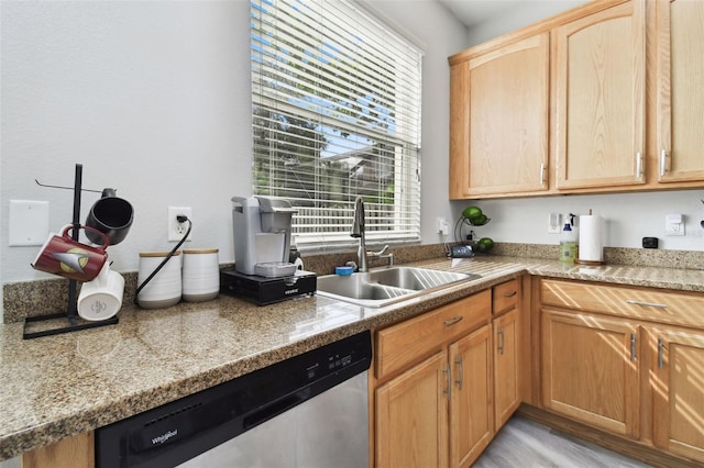 kitchen featuring light brown cabinets, dishwasher, and sink