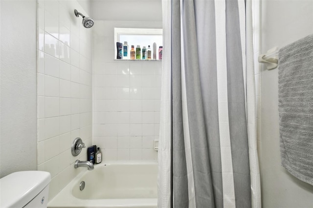 bathroom with shower / bath combination with curtain and toilet