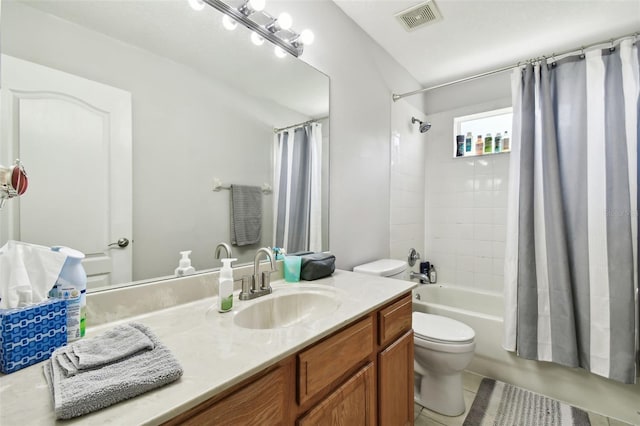 full bathroom featuring tile patterned floors, shower / bath combo, vanity, and toilet