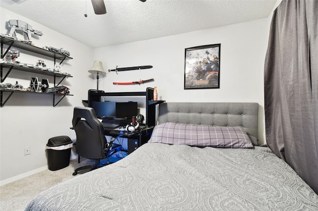 bedroom featuring ceiling fan, carpet floors, and a textured ceiling