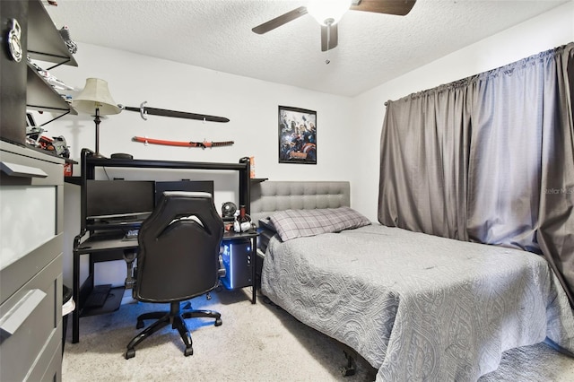 carpeted bedroom featuring ceiling fan and a textured ceiling