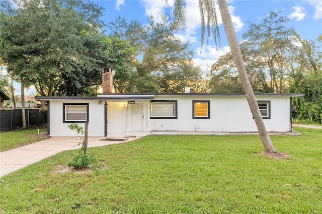 ranch-style house with a front lawn