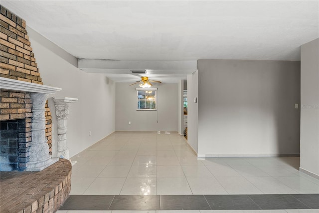 unfurnished living room with a brick fireplace, ceiling fan, and light tile patterned floors