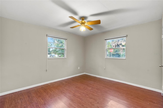 unfurnished room with hardwood / wood-style flooring, ceiling fan, and a wealth of natural light