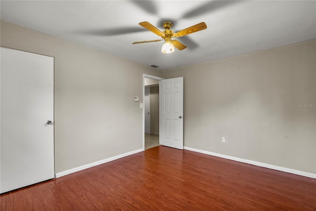 unfurnished room with dark hardwood / wood-style flooring and ceiling fan