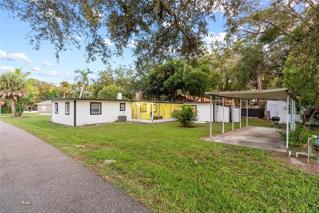 exterior space with cooling unit and a front yard