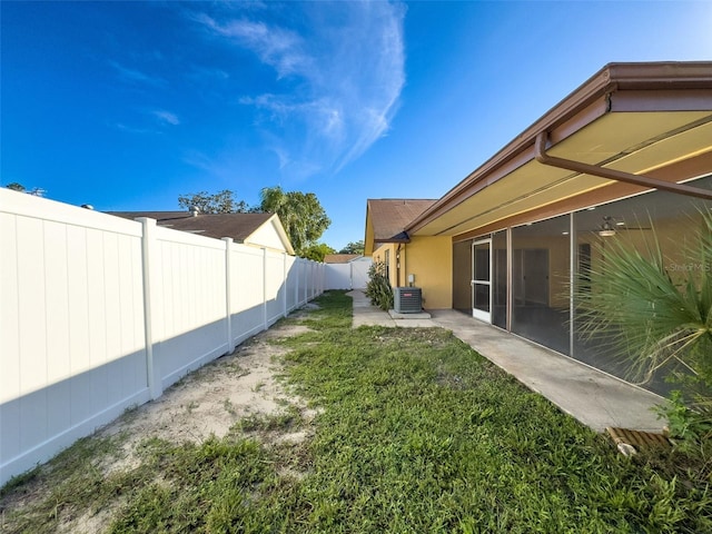 view of yard with cooling unit and a fenced backyard