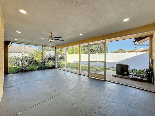 unfurnished sunroom featuring ceiling fan