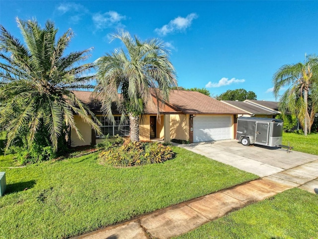 view of front of home with concrete driveway, stucco siding, a garage, and a front lawn