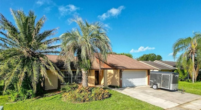 view of front of property featuring a front lawn, stucco siding, a garage, and concrete driveway