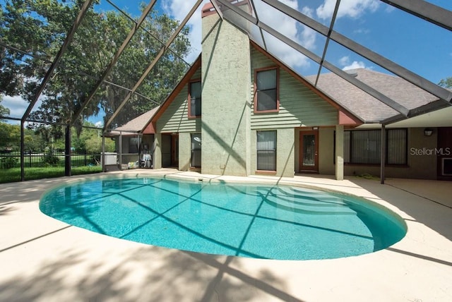 view of swimming pool with a lanai and a patio