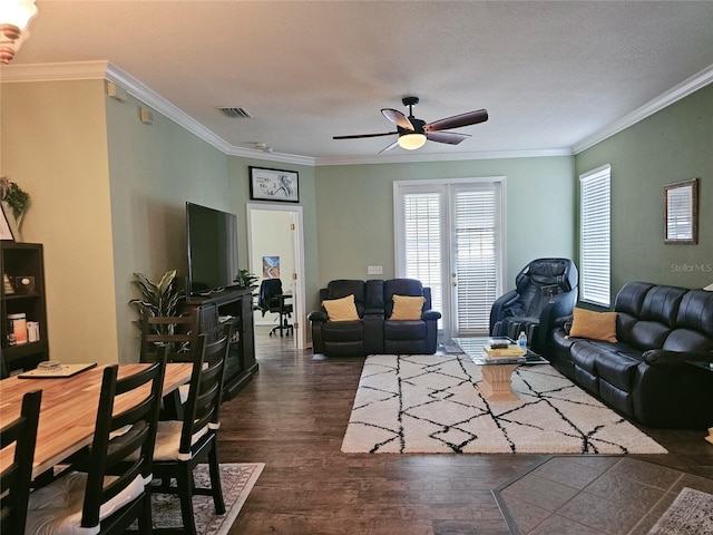 living room featuring ornamental molding, ceiling fan, a textured ceiling, and dark hardwood / wood-style floors